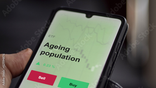 An investor's analyzing the ageing population etf fund on a screen. A phone shows the prices of aged THERAPEUTICS MEDICAL 