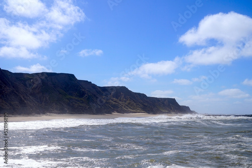 Rough surf with North Sea waves in the foreground at the cliffs of the coast at Ferring, Lemvig, Jutland, Denmark