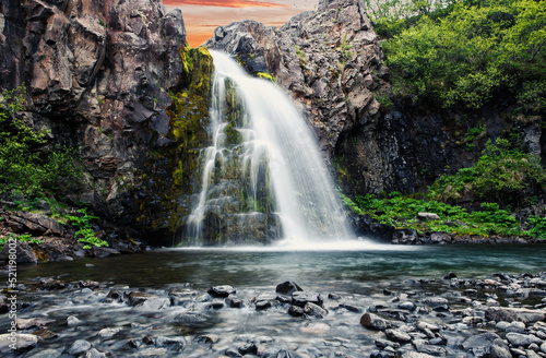 Majestic nature of Iceland. person with  standing in waterfall Gljufrabui. Is one famous natural landmark and travel destination place. Iconic location for landscape photographers