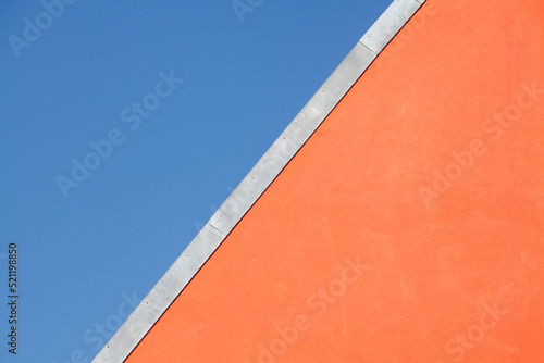 Dach, rote Hauswand, Dachkante, Blauer Himmel, Deutschland photo