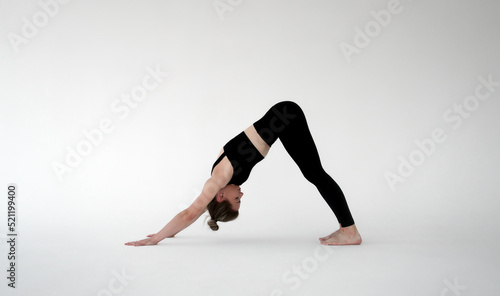 Young woman practicing yoga. Girl meditating and doing exercises. Training, workout, fitness, healthy lifestyle, self care, yoga, meditation, mindfulness concept © Margarita