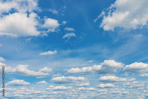 White clouds in the blue sky. White light cloudy heaven good weather. Summer sky. Heaven and infinity. Curly clouds on a sunny day. Beautiful bright blue background.