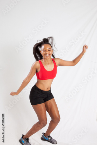 Happy woman in exercise outfit dancing