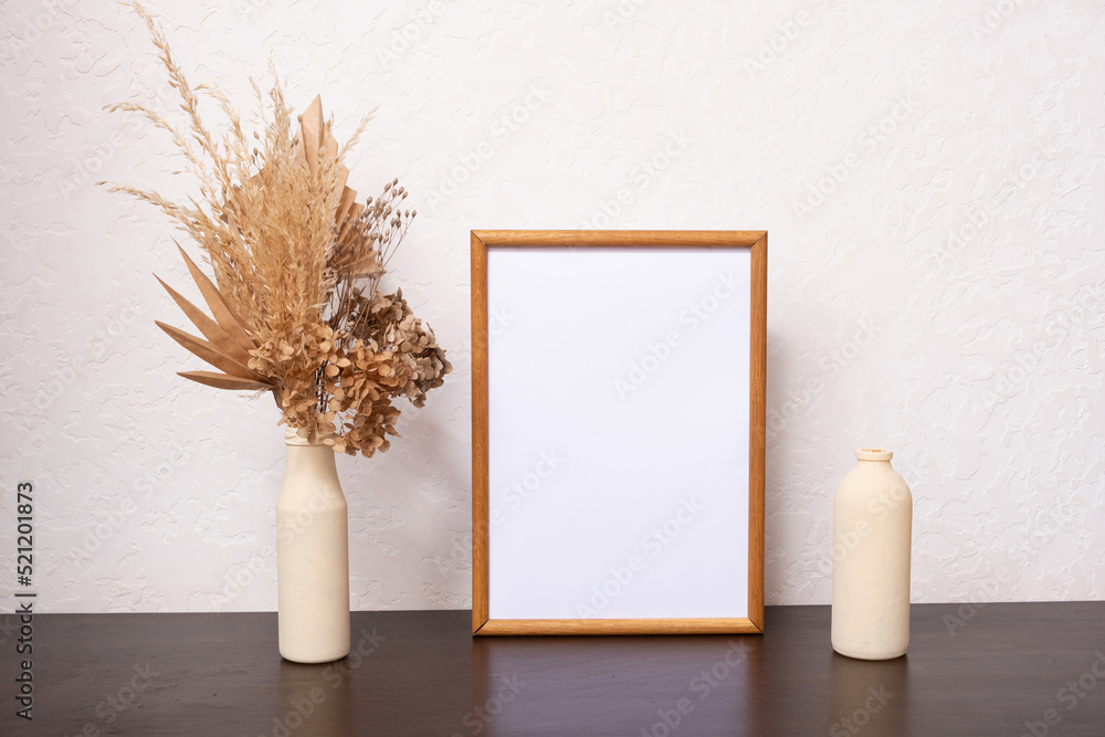 Mock up empty wooden frame mockup, dried leaf and pampass grass in vase on white background, interior, home design. Art concept. copy space