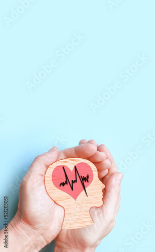 Hands holding wooden brain and heart, brain stroke, world heart day, world mental health day, Alzheimer concept