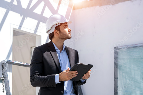 Εκτύπωση καμβά Manager using tablet checking the construction progress of the housing project