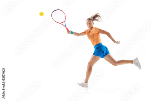 Portrait of young sportive woman, professional tennis player in motion, training isolated over white studio background © Lustre