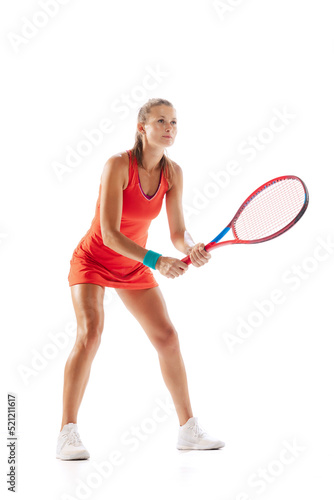 Portrait of young concentrated woman, professional tennis player posing with racket isolated over white studio background