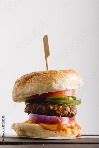 Close-up of fresh burger against white background, copy space