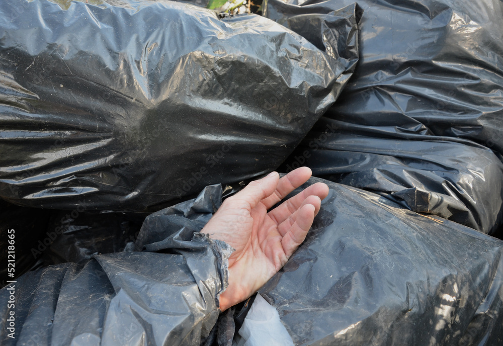 dead man in a black plastic garbage bag. bags for the dead from which a