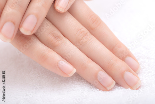 Beautiful natural fingernails and fingers of young woman after manicure
