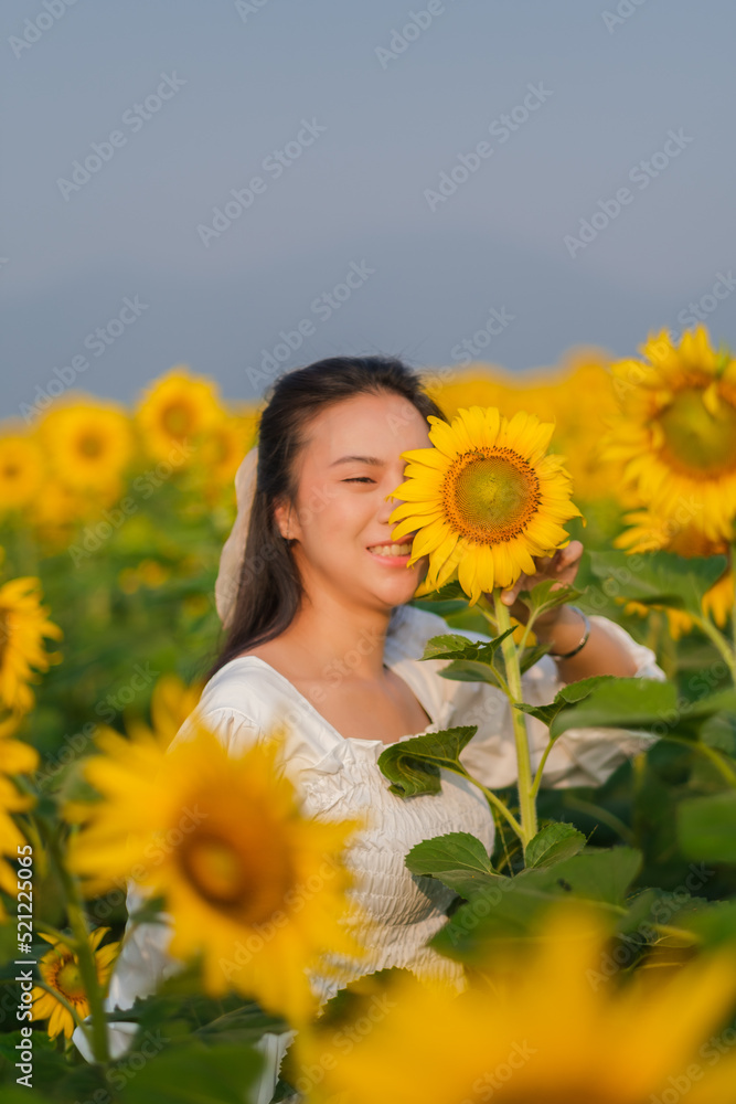beautiful sweet girl asia in a white dress walking on a field of sunflowers , smiling a beautiful smile,cheerful girl,style, lifestyle be happy beautiful sweet girl asia in a white dress walking on a field of sunflowers , smiling a beautiful smile,cheerful girl,style, lifestyle be happy