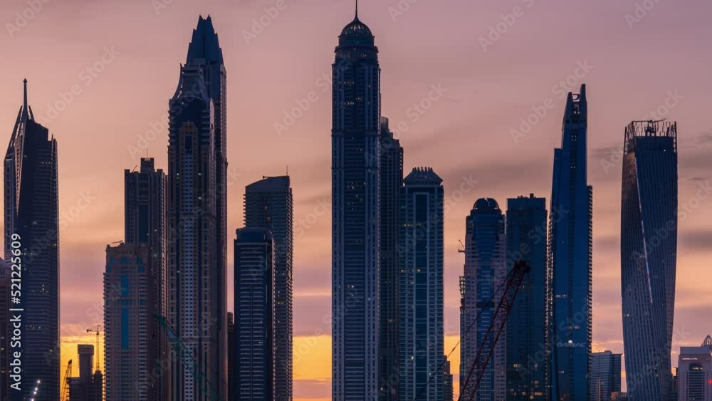 Dubai UAE-April 17,2019: Time lapse of sky sunrise with high rise building in Dubai Marina. Dubai UAE-April 17,2019: Time lapse of sky sunrise with high rise building in Dubai Marina.