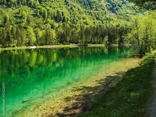 View of the Bluntausee lake surrounded with trees on a sunny day in Salzburg, Austria photo