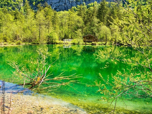 View of the Bluntausee lake surrounded with trees on a sunny day in Salzburg, Austria photo