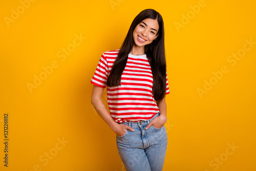 Photo of charming cute young lady wear red clothes arms pockets empty space isolated yellow color background