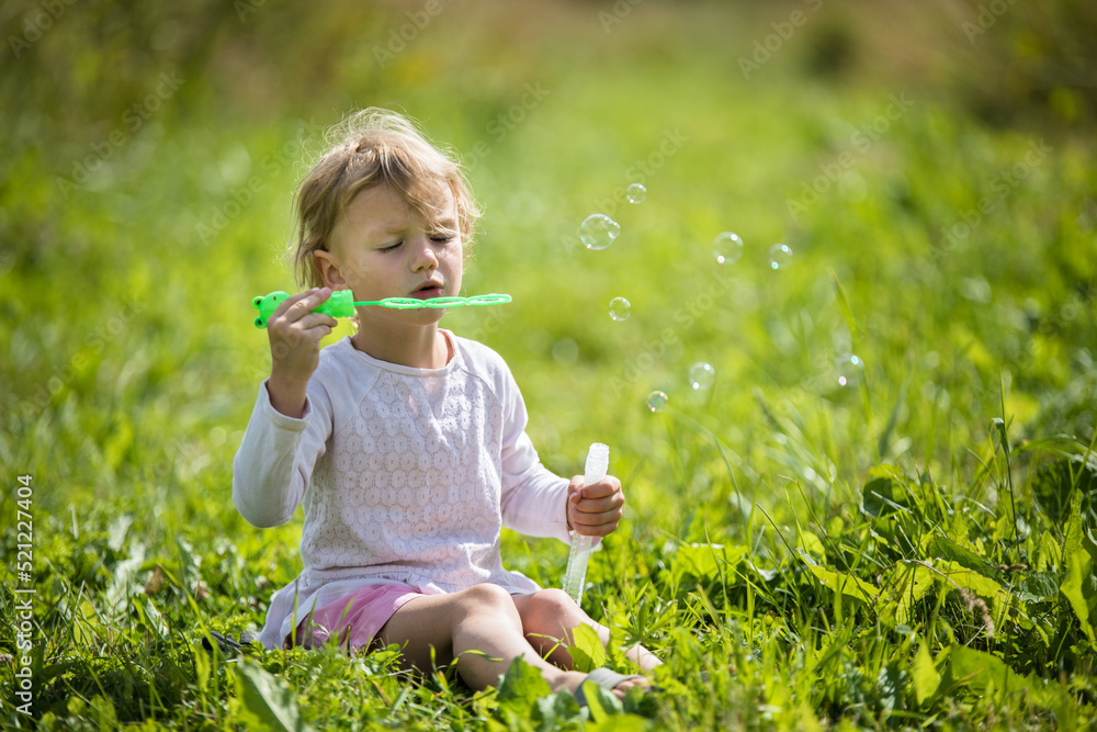Beautiful little girl, has happy fun cheerful smiling face, soap bubble blower. Beautiful little girl, has happy fun cheerful smiling face, soap bubble blower.