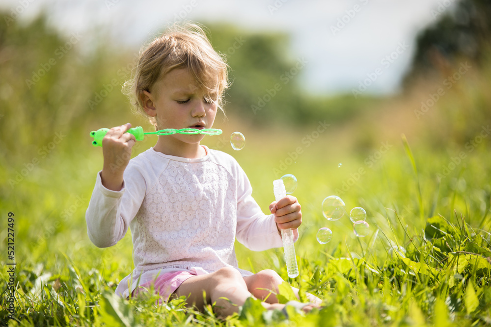 Beautiful little girl, has happy fun cheerful smiling face, soap bubble blower. Beautiful little girl, has happy fun cheerful smiling face, soap bubble blower.