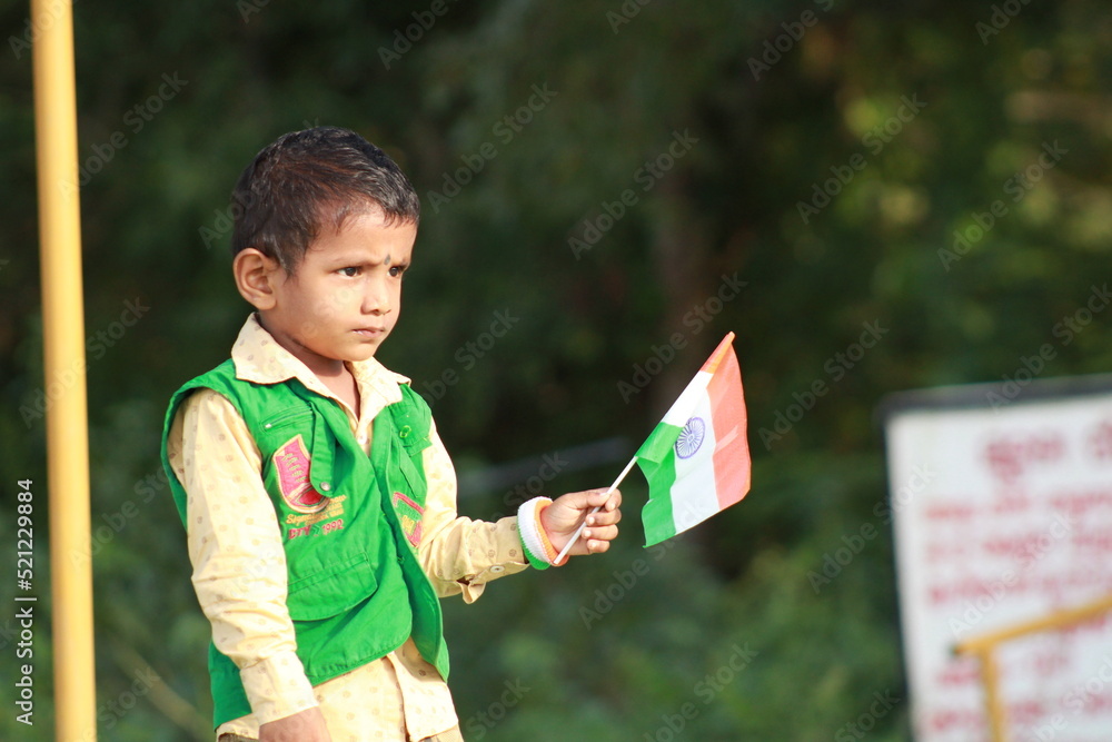 little indian boy proudly holding Tricolour Indian National flag. Stock