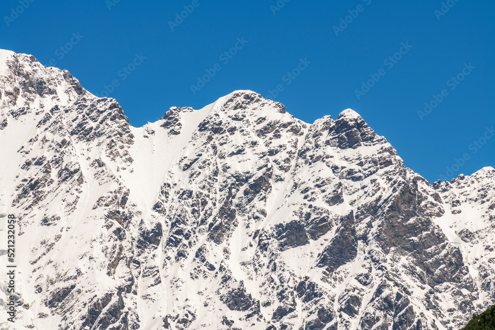 Shkhara mountains, the highest point in the nation of Georgia It is located near the Russian-Georgian border, in Russia's Kabardino-Balkaria region. Beautiful snow covered mountains. Shkhara mountains, the highest point in the nation of Georgia It is located near the Russian-Georgian border, in Russia's Kabardino-Balkaria region. Beautiful snow covered mountains.