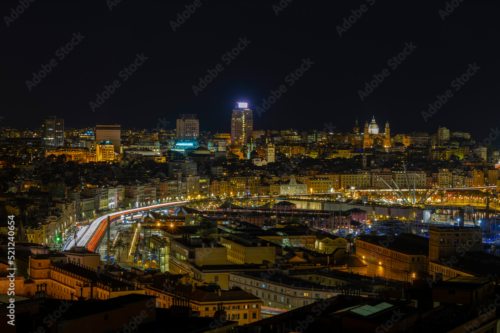 Panoramic view of Genoa at night with the causeway and the buidings of the historic center, Italy