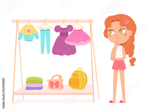 Pensive cute girl choosing dress hanging on wardrobe rack in fashion store or at home