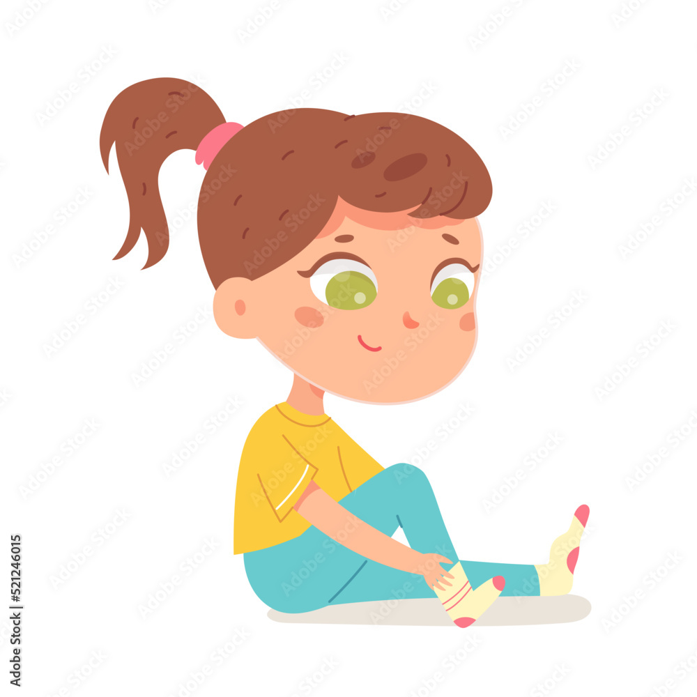 Cute girl putting on sock, isolated adorable kid sitting on floor to put foot underwear Cute girl putting on sock, isolated adorable kid sitting on floor to put foot underwear