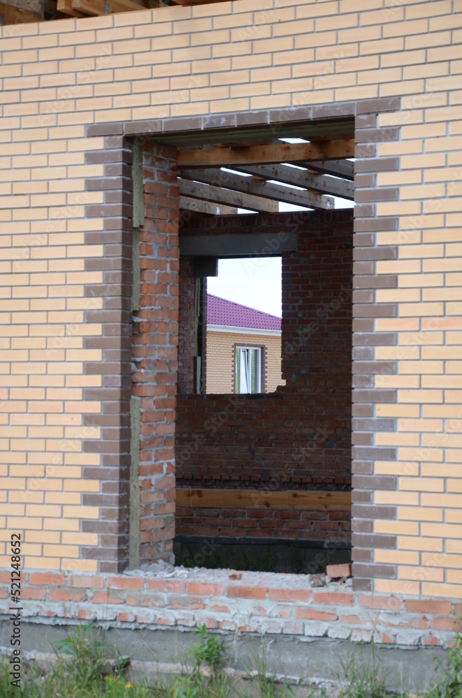  Construction of a brick and wooden roof house construction in progress