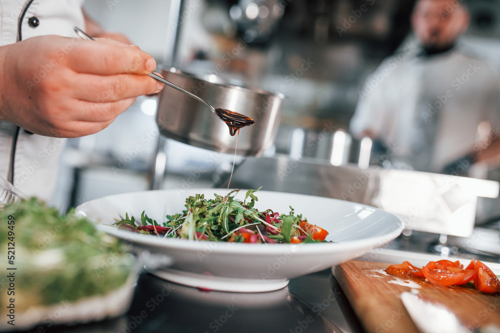 Close up view of vegetarian salad. Professional chef preparing food in the kitchen Close up view of vegetarian salad. Professional chef preparing food in the kitchen