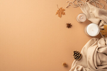 Autumn mood concept. Top view photo of candles anise yellow maple leaves pine cones and plaid on isolated beige background with copyspace