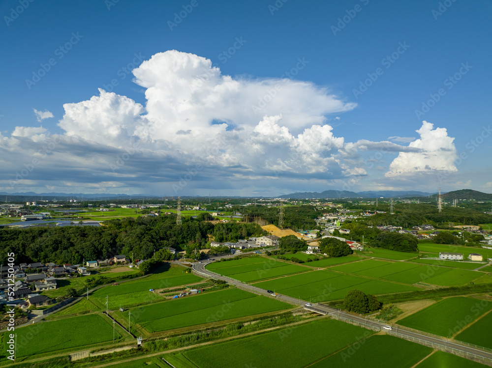 Billowy white clouds over rural farms and landscape on sunny day
