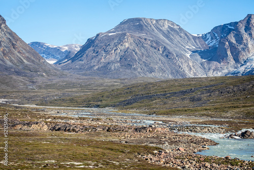 Landscape of mountains and meltwater river at Camp Frieda on the Disko Bay coast, Greenland on 18 July 2022