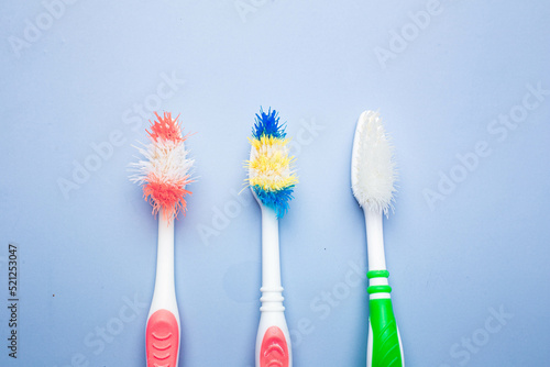 Wallpaper Mural Used old toothbrush on blue background. dental care concept Torontodigital.ca