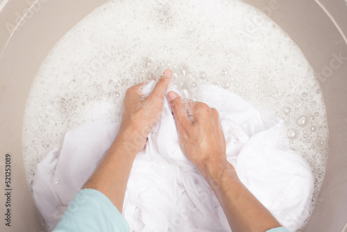 Wallpaper Mural Woman washing white clothes in tub, laundry concept Torontodigital.ca