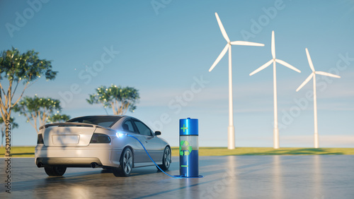 The electric car charging at the natural park with windmill in scene.