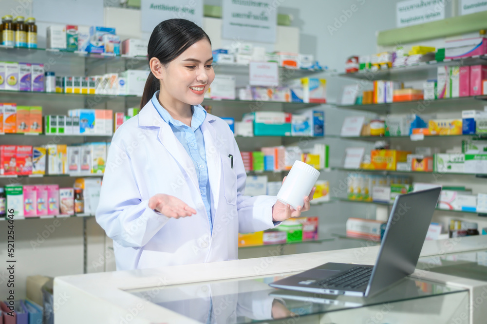 Female pharmacist counseling customer via video call in a modern pharmacy drugstore. Female pharmacist counseling customer via video call in a modern pharmacy drugstore.