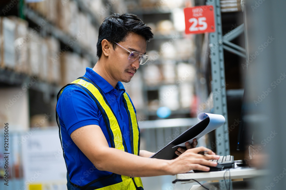 Asian warehouse workers in security uniforms use computers to inspect goods in warehouse inventory. Analysis of new arrivals to place them in the storage department. Work at the warehouse. Asian warehouse workers in security uniforms use computers to inspect goods in warehouse inventory. Analysis of new arrivals to place them in the storage department. Work at the warehouse.