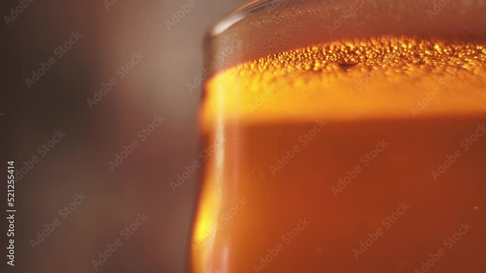 Beer with bubbles and foam in glass. Closeup Beer with bubbles and foam in glass. Closeup