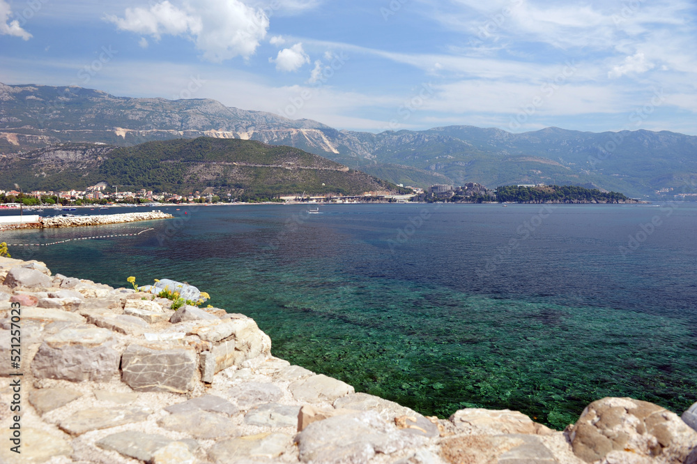 View from Budva towards mountains in Montenegro. Coast of the Adriatic Sea. Turquoise blue water.