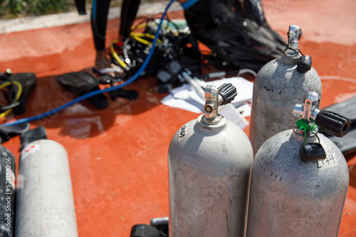 Close-up of scuba diving tanks on a tropical beach in Mexico. In the background the Caribbean Sea. Refueling diving cylinders.