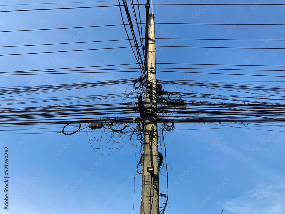 tangled wires in Thailand, on light poles, overgrown electrical wires
