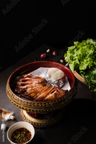 Fotografija Close up grilled pork jowl with sticky rice and spicy sauce in Thai stlye plate