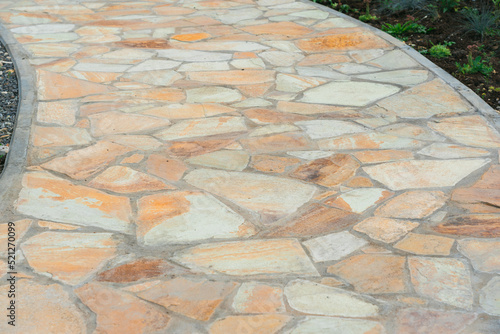 Garden path made of yellow sandstone stones