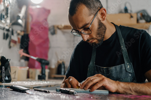 Close-up  artisan sculptor artist man at work in his workshop