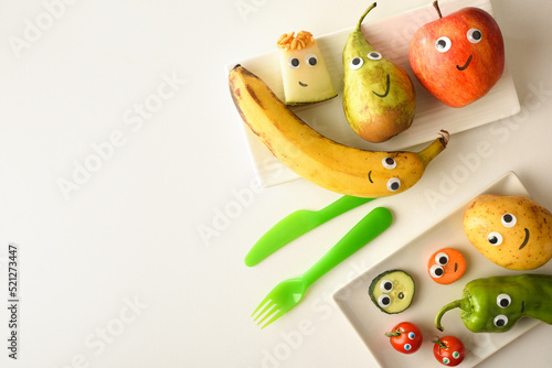Background with funny fruit plate served for children on table