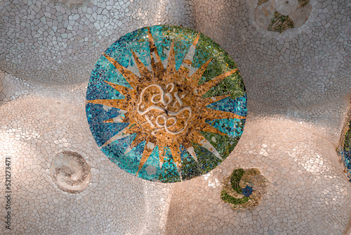 Ceiling with colorful mosaic sun in Guell Park in Barcelona, Spain