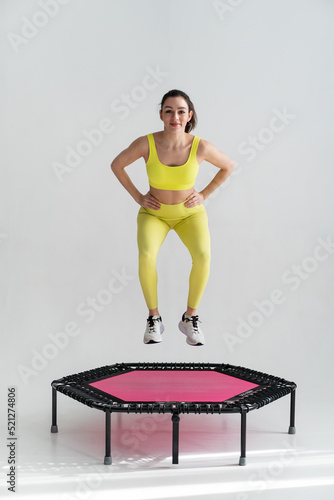 young fitness woman In sportswear jumping on sport trampoline