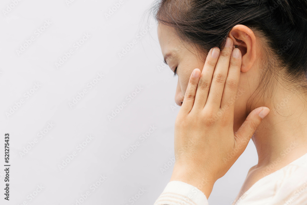 Asian woman suffering from earache. Symptoms of acute external otitis media. Health care concept. Asian woman suffering from earache. Symptoms of acute external otitis media. Health care concept.