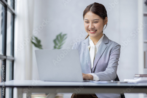 Young business Asian woman reviewing data in financial charts and graphs on workplace Accounting financial analyzing reports project concept.