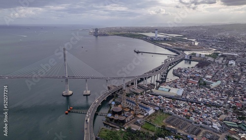 Aerial view of seaside Cebu cityscape and Cebu-Cordova bridge in the Philippines